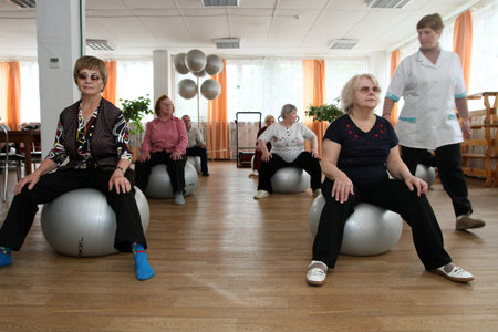 PODPOROZHYE, RUSSIA - JUNE 4: Day of Health in Center of social services for pensioners and the disabled Otrada (gymnastics with ball for elders), June 4, 2010 in Podporozhye, Russia.のeditorial素材