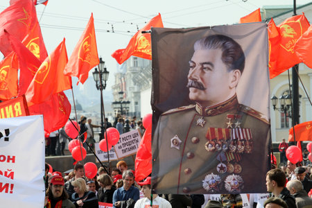 MOSCOW - MAY 1: Communist party supporters take part in a rally marking the May Day, a portrait of Soviet dictator Josef Stalin, May 1, 2010 in Moscow, Russia.のeditorial素材