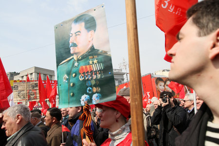 MOSCOW - MAY 1: Communist party supporters take part in a rally marking the May Day, a portrait of...