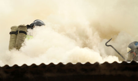 MOSCOW - APRIL 30: Firefighters extinguishing fire at the Viking floating restaurant on the Berezhkovskaya embankment, April 30, 2010 in Moscow, Russia.のeditorial素材