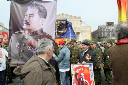 MOSCOW - MAY 1: Communist party supporters take part in a rally marking the May Day, a portrait of Soviet dictator Josef Stalin seen in the background, May 1, 2010 in Moscow, Russia.のeditorial素材