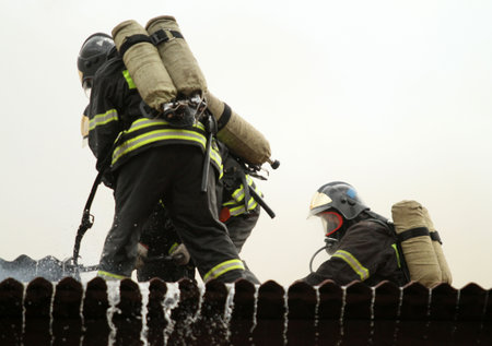 MOSCOW - APRIL 30: Firefighters extinguishing fire at the Viking floating restaurant on the Berezhkovskaya embankment, April 30, 2010 in Moscow, Russia.のeditorial素材
