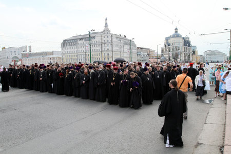 MOSCOW - MAY 24: Orthodox clergymen walk near the Kremlin, while celebrating the Holiday of St....