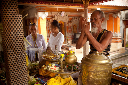 BALI, INDONESIA - MARCH 28: Hindu Brahmin during the ceremonies of Oton - is the first ceremony for baby on which the infant is allowed to touch the ground on March 28, 2012 on Bali, Indonesia.のeditorial素材