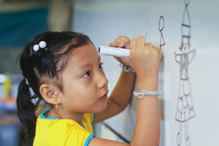 GUAYAQUIL, ECUADOR - FEBRUARY 8: Unknown kid in lesson drawing in primary school by project to help...