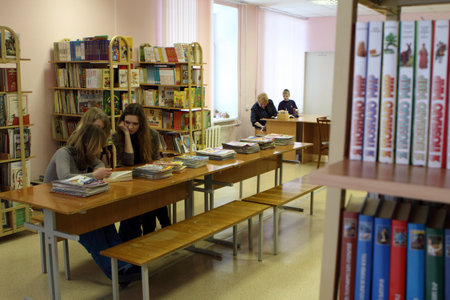PODPOROZHYE, RUSSIA - JANUARY 31: Open Day at the Podporozhye's Children House - unknown children in the library read books with teachers, January 31, 2010 in Podporozhye, Russia.のeditorial素材