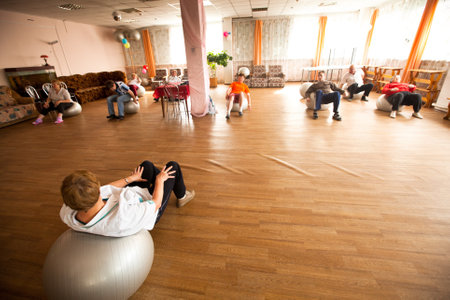 PODPOROZHYE, RUSSIA - JULY 5: Day of Health in Center of social services for pensioners and disabled Otrada (gymnastics with ball for eldery and disabled), July 5, 2012 in Podporozhye, Russia.のeditorial素材