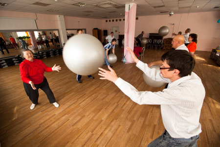 PODPOROZHYE, RUSSIA - JULY 5: Day of Health in Center of social services for pensioners and disabled Otrada (gymnastics with ball for eldery and disabled), July 5, 2012 in Podporozhye, Russia. のeditorial素材