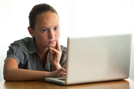 Portrait of a young girl, working on laptop