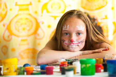 Portrait of young girl with paint of face.