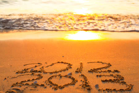 Conceptual photo  New Year 2013 is coming  - inscription 2012 and 2013 on a beach sandの写真素材