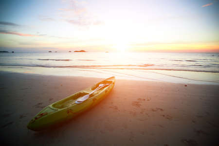 Kayak at the tropical beach at sunset の写真素材