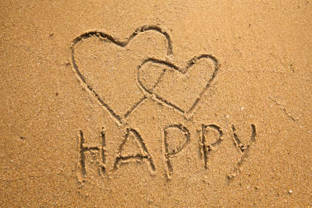 Texture of sand  the inscription happy and two hearts  concept Valentine Day の写真素材