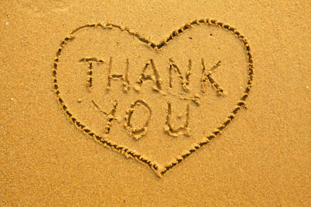 Texture of sand  the inscription inside the heart of Thank You の写真素材