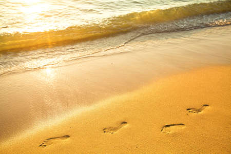 Footprint on sand with foam の写真素材