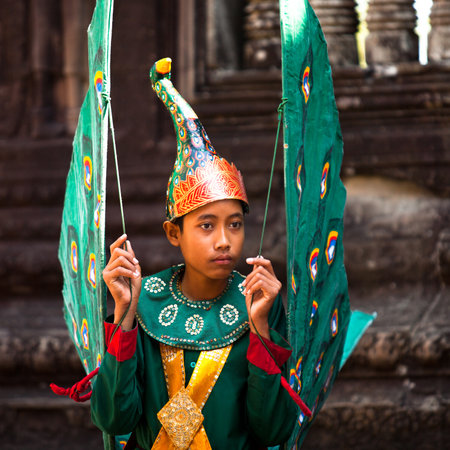 SIEM REAP, CAMBODIA - DEC 13: An unidentified cambodians in national dress poses for tourists in Angkor Wat, Dec 13, 2012 on Siem Reap, Cambodia. Angkor is the country's prime attraction for visitors.のeditorial素材