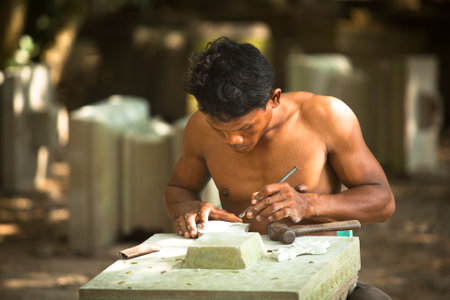 SIEM REAP, CAMBODIA - DEC 13: Unidentified cambodian stonecutter for restoration works in Angkor Wat, Dec 13, 2012 on Siem Reap, Cambodia. Angkor Wat is the countryのeditorial素材