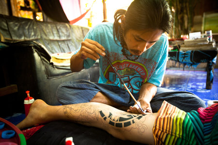 CHANG, THAILAND - DEC 24: Unidentified master makes traditional tattoo bamboo, Dec 24, 2012 in Chang, Thailand. Thai tattooists are very popular among tourists, prices range from 500 thai baht and up.のeditorial素材