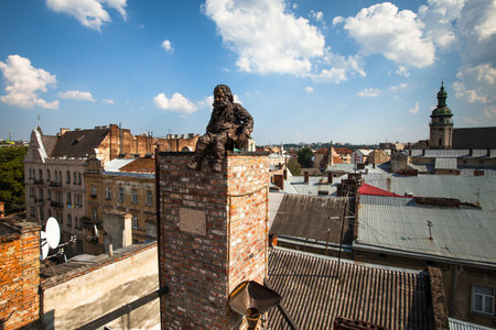 LVIV, UKRAINE - AUG 6: Chimneysweep monument is on the roof of a historic building House of Legends on Aug 6, 2012 in Lviv, Ukraine. On 12 Jun 2009 the Ukrainian magazine Focus judged Lviv the best Ukrainian city to live in.のeditorial素材