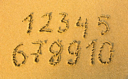 Numbers one to ten written on a sandy beach の写真素材