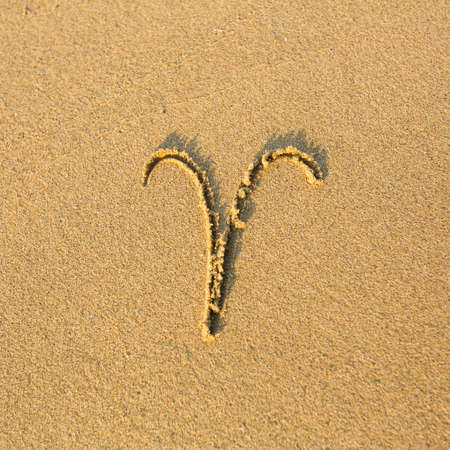 Zodiac sign Aries, drawn on the facture beach sand   zodiac signs series の写真素材