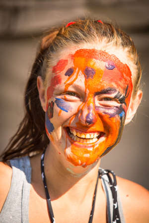 Portrait of an emotional young girl with paint on his face