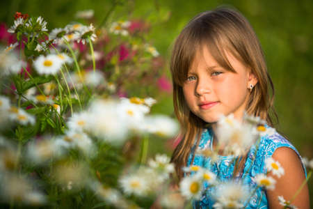 Little beautiful girl outdoor among wildflowersの写真素材
