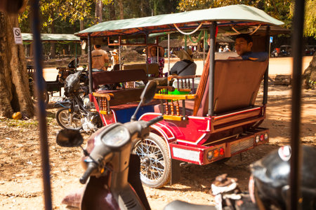 SIEM REAP, CAMBODIA - DEC 13: Unidentified cambodian moto-rickshaws in Angkor Wat, Dec 13, 2012 on...