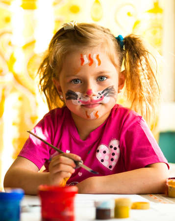 Hobby: Child, drawing paint with paint of face.の写真素材