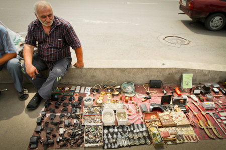TBILISI, GEORGIA - JUL 17: An unidentified seller on Dry Bridge market, Jul 17, 2011 in Tbilisi, Georgia. Dry bridge built in 1881 by Giovanni Skudieri, today is most famous flea market in Georgia.のeditorial素材