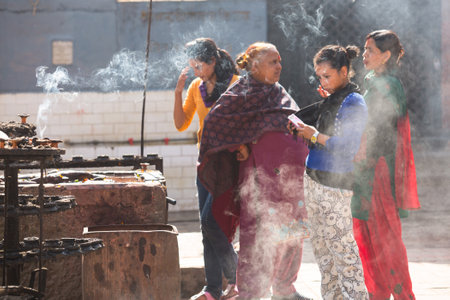 KATHMANDU, NEPAL - NOV 30: Unidentified pilgrims circle stupa Boudhanath, Nov 30, 2013 in Kathmandu,...
