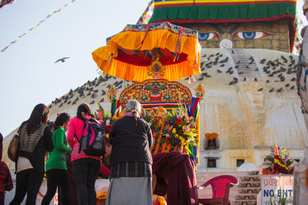 KHATMANDU, NEPAL - DEC 15: Unidentified Buddhist pilgrims near stupa Boudhanath during festive...