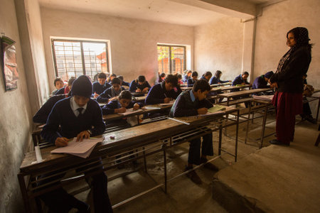 KATHMANDU, NEPAL - DEC 19: Unknown children in the lesson at public school, Dec 19, 2013 in Kathmandu, Nepal. Adult literacy (age 15+) 60.3% (female: 46.3%, male: 73%) in a 2010 population census.のeditorial素材