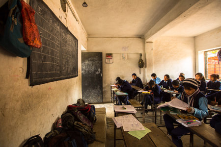KATHMANDU, NEPAL - DEC 19: Unknown children in the lesson at public school, Dec 19, 2013 in Kathmandu, Nepal. Adult literacy (age 15+) 60.3% (female: 46.3%, male: 73%) in a 2010 population census.のeditorial素材