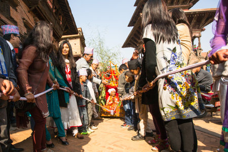 BHAKTAPUR, NEPAL - DEC 20: Unidentified people during Birthday celebration head of family - 77 years 7 months 7 days 7 hours old, like rebirth according to Newar, Dec 20, 2013 in Bhaktapur, Nepal.のeditorial素材