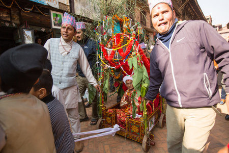BHAKTAPUR, NEPAL - DEC 20: Unidentified people during Birthday celebration head of family - 77 years 7 months 7 days 7 hours old, like rebirth according to Newar, Dec 20, 2013 in Bhaktapur, Nepal.のeditorial素材