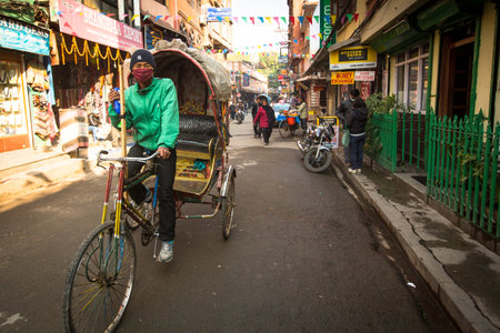 KATHMANDU, NEPAL - NOV 28: Unidentified nepali rickshaw in historic center of city, Nov 28, 2013 in Kathmandu, Nepal. Largest city of Nepal, its historic center, a population of over 1 million people.のeditorial素材