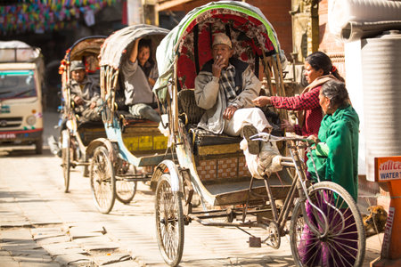 KATHMANDU, NEPAL - NOV 28: Unidentified nepali rickshaw in historic center of city, Nov 28, 2013 in Kathmandu, Nepal. Largest city of Nepal, its historic center, a population of over 1 million people.のeditorial素材