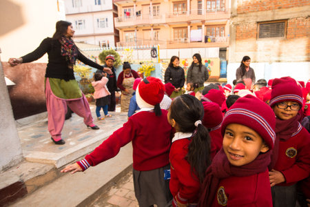 KATHMANDU, NEPAL - DEC 22: Unknown pupils during dance lesson in primary school, Dec 22, 2013 in Kathmandu, Nepal. Only only 25% of girls attend schools and half of the children can reach the 5 grade.のeditorial素材