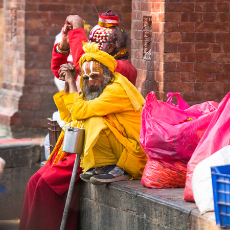 KATHMANDU, NEPAL - DEC 2: Unknown Sadhu Monks sitting in Durbar Square, Dec 2, 2013 in Kathmandu, Nepal. のeditorial素材