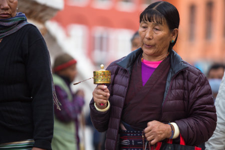 KATHMANDU, NEPAL - DEC 2: Unidentified pilgrims circle stupa Boudhanath, Dec 2, 2013 in Kathmandu, Nepal. Ancient Stupa is one of the largest in the world, of 1979 is a UNESCO World Heritage Site.のeditorial素材