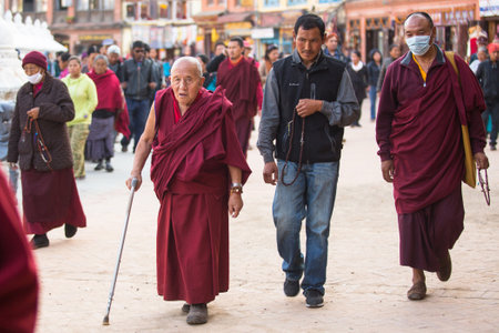 KATHMANDU, NEPAL - DEC 2: Unidentified pilgrims circle stupa Boudhanath, Dec 2, 2013 in Kathmandu, Nepal. Ancient Stupa is one of the largest in the world, of 1979 is a UNESCO World Heritage Site.のeditorial素材