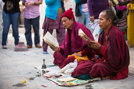 KATHMANDU, NEPAL - DEC 2: Unidentified pilgrims circle stupa Boudhanath, Dec 2, 2013 in Kathmandu, Nepal. Ancient Stupa is one of the largest in the world, of 1979 is a UNESCO World Heritage Site.のeditorial素材