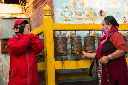 KATHMANDU, NEPAL - DEC 2: Unidentified pilgrims circle stupa Boudhanath, Dec 2, 2013 in Kathmandu, Nepal. Ancient Stupa is one of the largest in the world, of 1979 is a UNESCO World Heritage Site.のeditorial素材