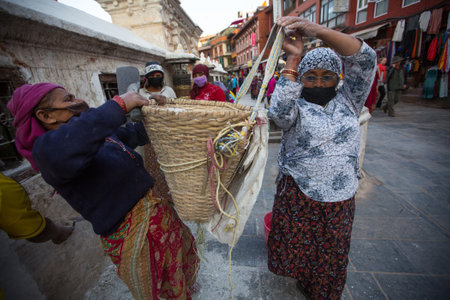 KATHMANDU, NEPAL - DEC 3: Unidentified workers repairing of Stupa Boudhanath, Dec 3, 2013 in Kathmandu, Nepal. Stupa is one of the largest in the world, of 1979 is a UNESCO World Heritage Site.のeditorial素材