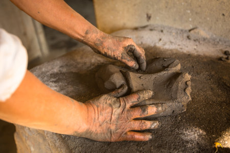 BHAKTAPUR, NEPAL - DEC 7: Unidentified Nepalese man working in the his pottery workshop, Dec 7, 2013 in Bhaktapur, Nepal. 100 cultural groups have created an image Bhaktapur as Capital of Nepal Arts.のeditorial素材