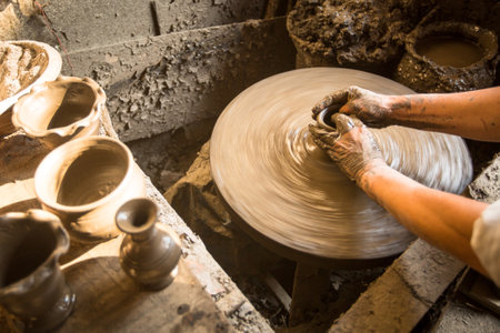 BHAKTAPUR, NEPAL - DEC 7: Unidentified Nepalese man working in the his pottery workshop, Dec 7, 2013 in Bhaktapur, Nepal. 100 cultural groups have created an image Bhaktapur as Capital of Nepal Arts.のeditorial素材