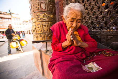 KATHMANDU, NEPAL - DEC 2: Unidentified pilgrims circle stupa Boudhanath, Dec 2, 2013 in Kathmandu, Nepal. Ancient Stupa is one of the largest in the world, of 1979 is a UNESCO World Heritage Site.のeditorial素材