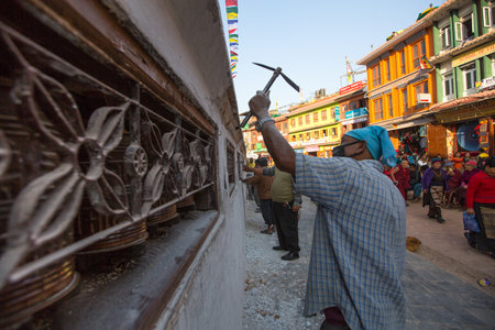 KATHMANDU, NEPAL - DEC 2: Unidentified workers repairing of Stupa Boudhanath, Dec 2, 2013 in Kathmandu, Nepal. Stupa is one of the largest in the world, of 1979 is a UNESCO World Heritage Site.のeditorial素材