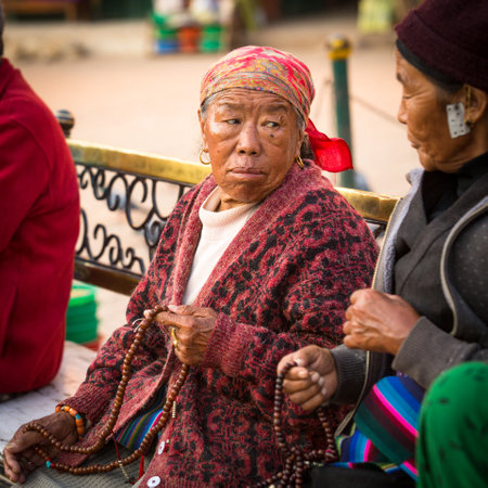 KATHMANDU, NEPAL - DEC 2: Unidentified pilgrims circle stupa Boudhanath, Dec 2, 2013 in Kathmandu, Nepal. Ancient Stupa is one of the largest in the world, of 1979 is a UNESCO World Heritage Site.のeditorial素材